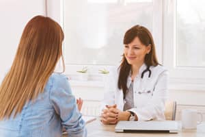 friendly female doctor has a discussion with a female patient in a codeine addiction rehab center